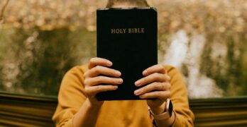 person holding black book during daytime