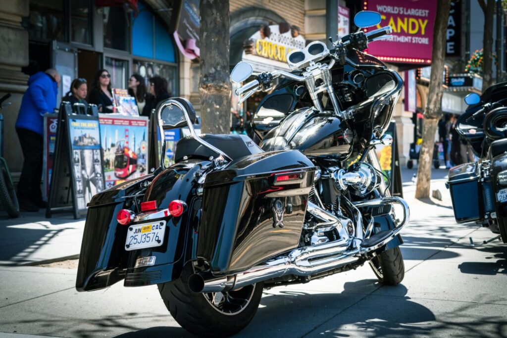 A Harley Davidson motorbike parked on Fisherman's Wharf in San Francisco, capturing urban street life.
