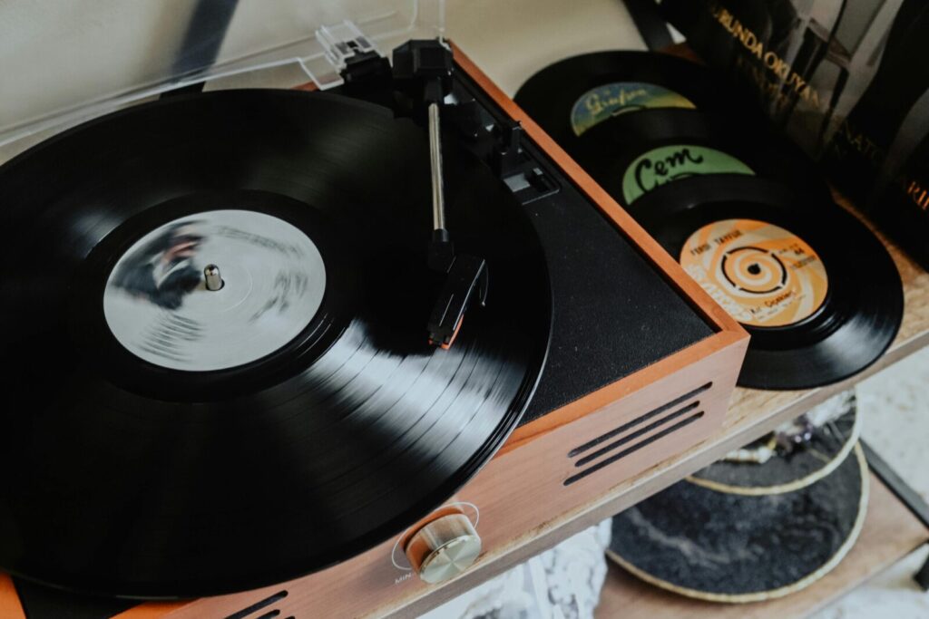 Close-up of a classic turntable playing vinyl records, evoking nostalgia and retro vibes.