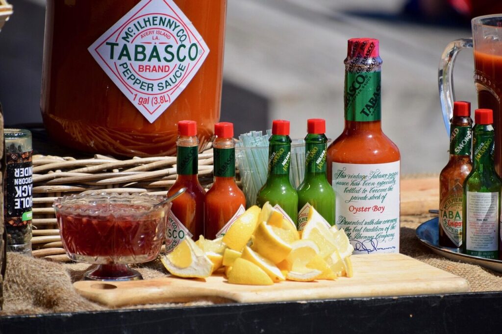 display table, food, food stall, lemon slices, lemons, food market, market stall, sauce, sauces, tabasco sauce, hot pepper sauce, outdoors, tabasco sauce, tabasco sauce, tabasco sauce, tabasco sauce, tabasco sauce