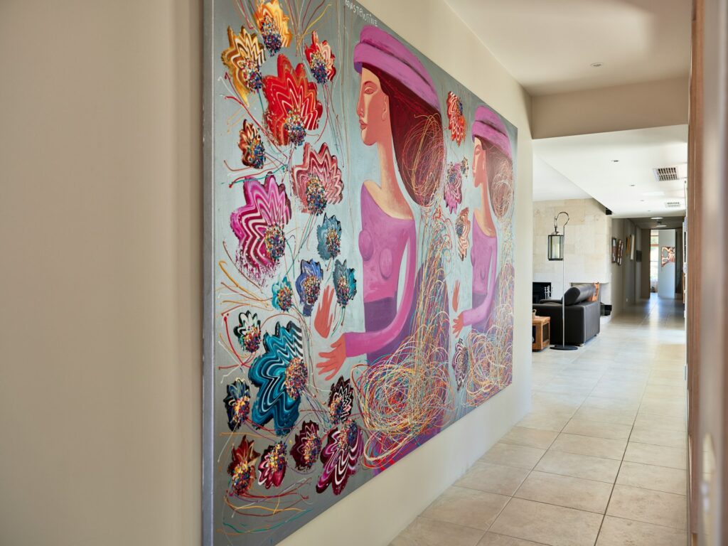 A hallway with a large painting on the wall