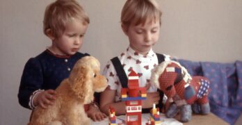 two children playing toys on table