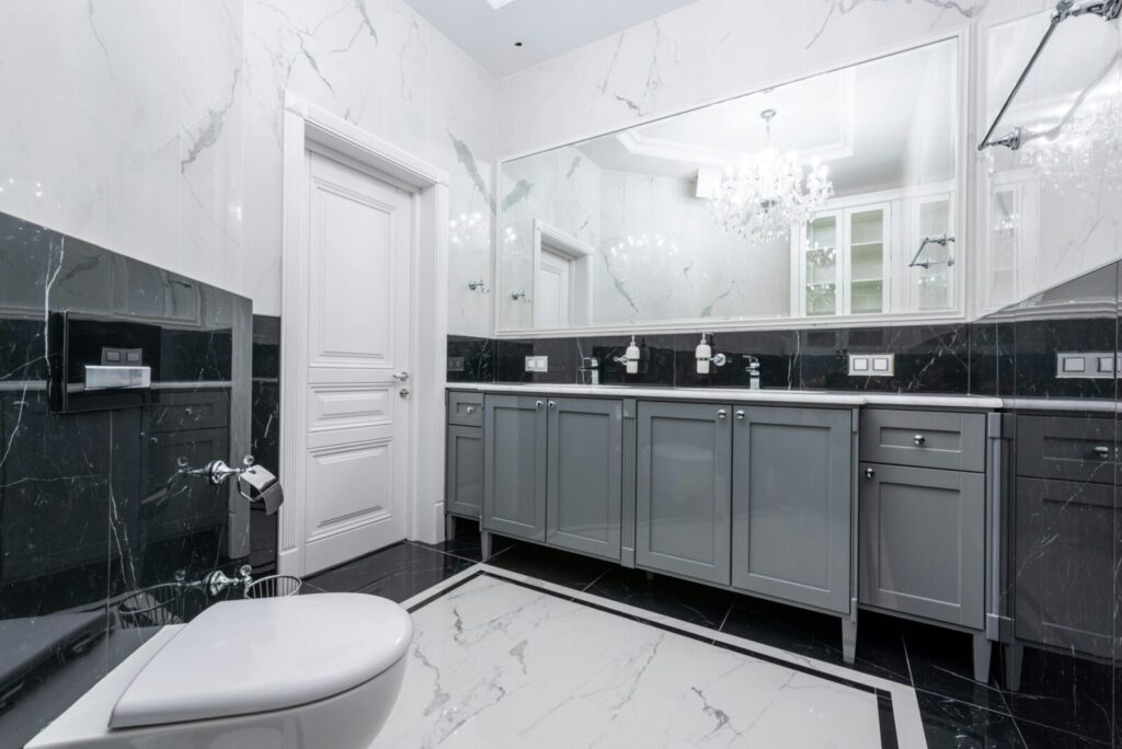 Elegant modern bathroom featuring marble walls and chic cabinetry.