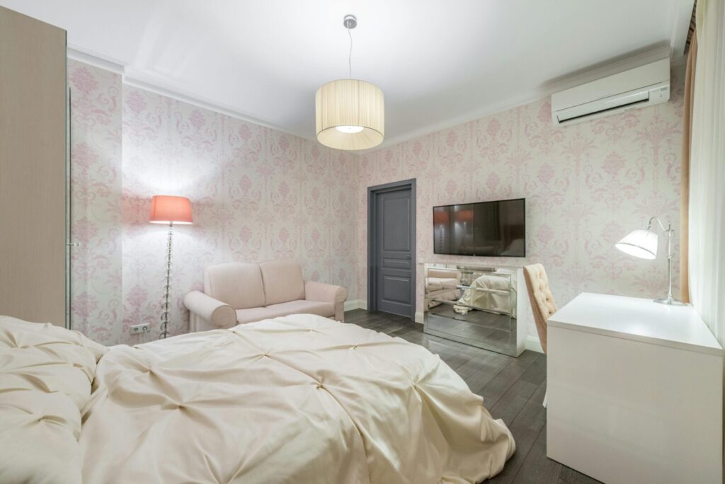 A stylish modern bedroom featuring a comfortable bed, sleek decor, and a wall-mounted TV for a relaxing ambiance.