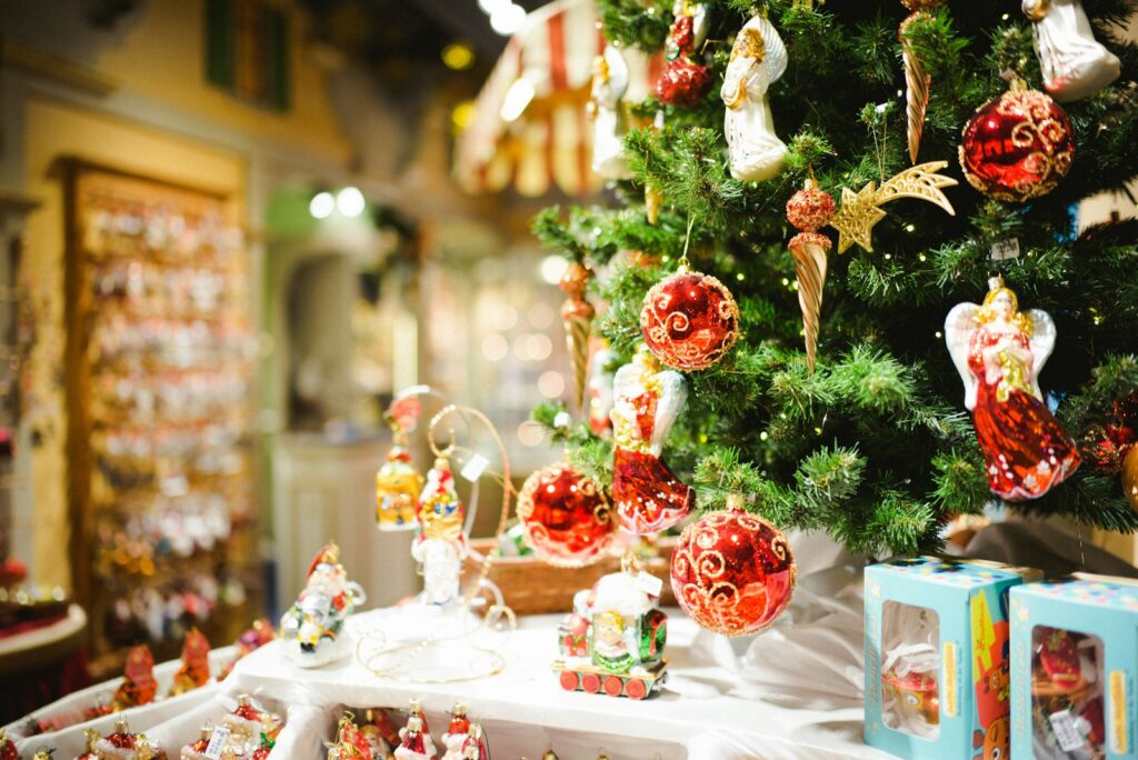 red and white christmas tree with baubles and gift boxes