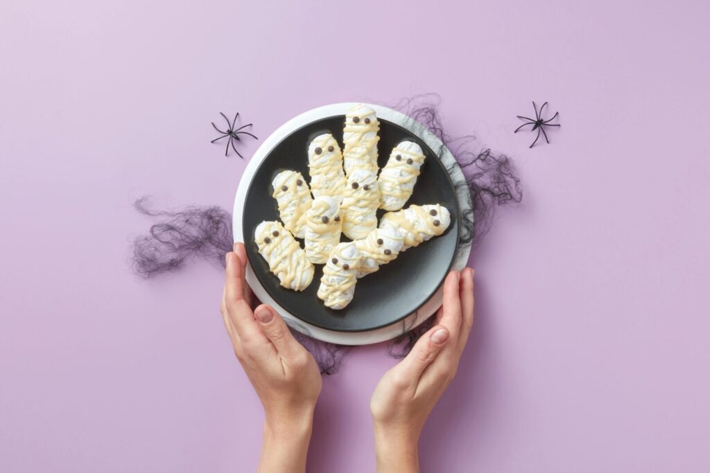 Discover delightful Halloween mummy cookies on a plate, perfect for spooky celebrations.