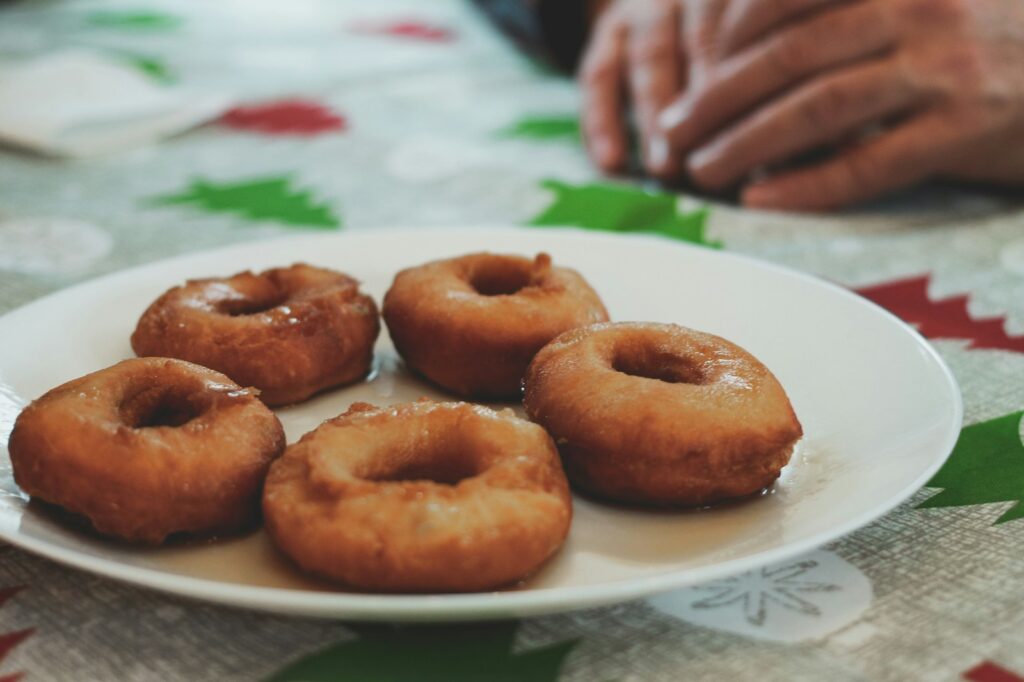 a white plate topped with donuts on top of a table