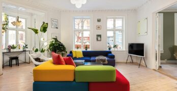 A living room filled with furniture and lots of windows