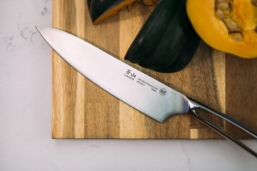 silver knife on wooden board