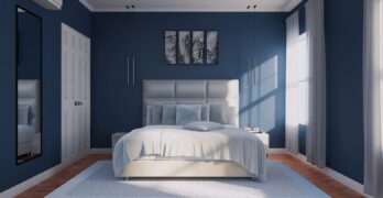 a bedroom with blue walls and a white bed