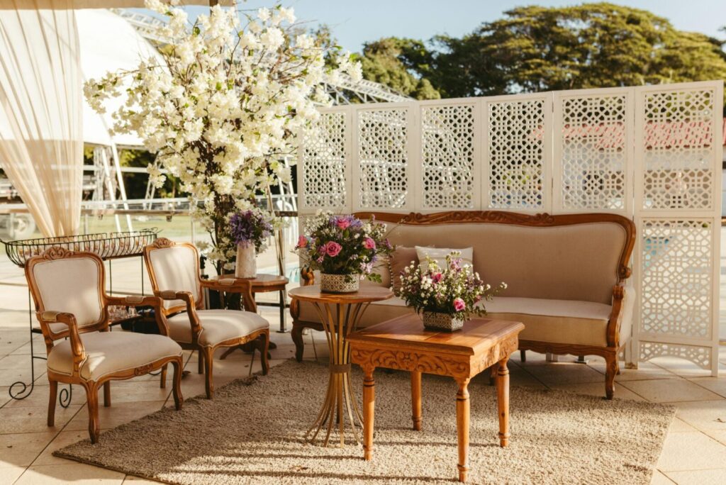 Charming outdoor patio with vintage furniture and floral decor, perfect for relaxation.