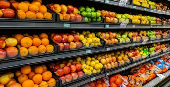 yellow and red apples on black plastic crate