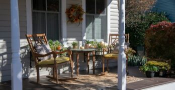 brown wooden chairs and table near white wooden post