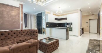 Luxurious open-plan living room with modern interior design and stylish lighting features.