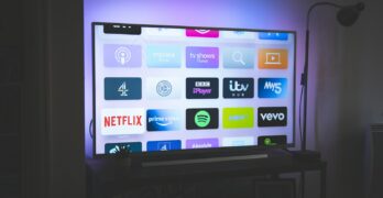 black flat screen tv turned on showing game