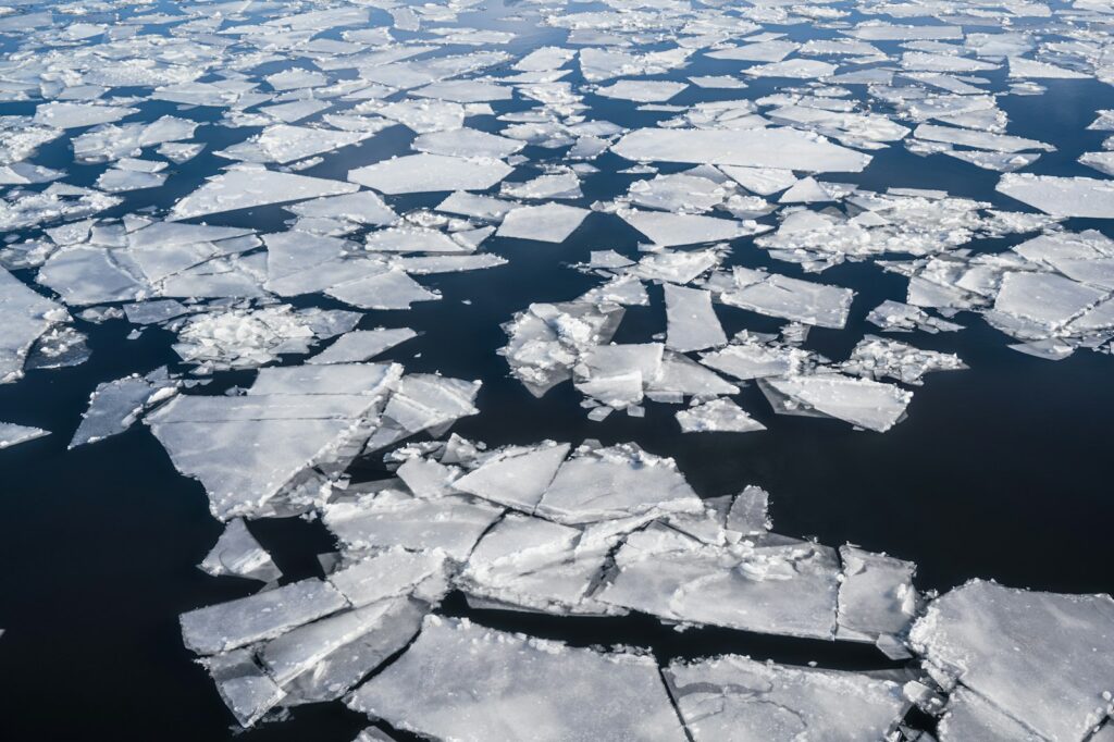 an aerial view of ice floes floating in the water