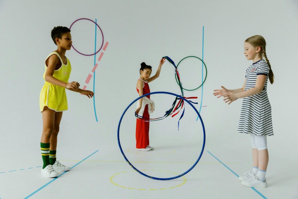 A fun indoor scene with diverse kids playing with colorful hula hoops, emphasizing play and friendship.