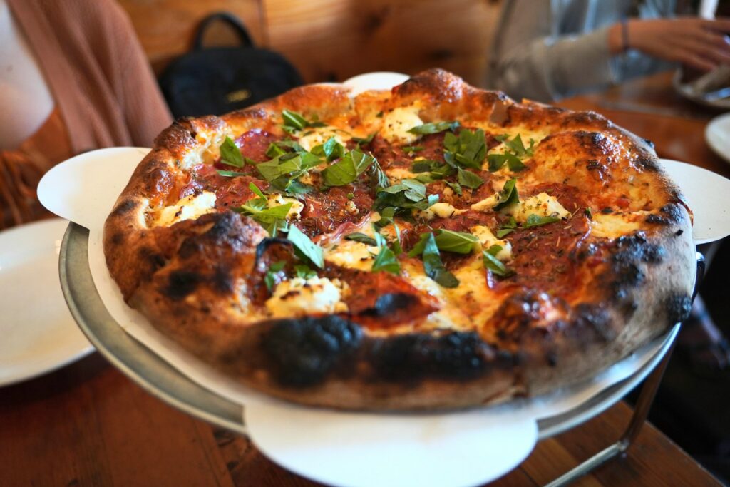 Here's a caption: fresh pizza, ready to be eaten.
