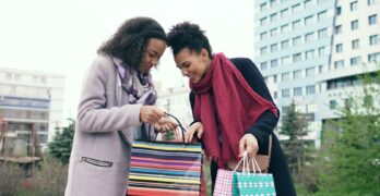 Two women looking into shopping bags