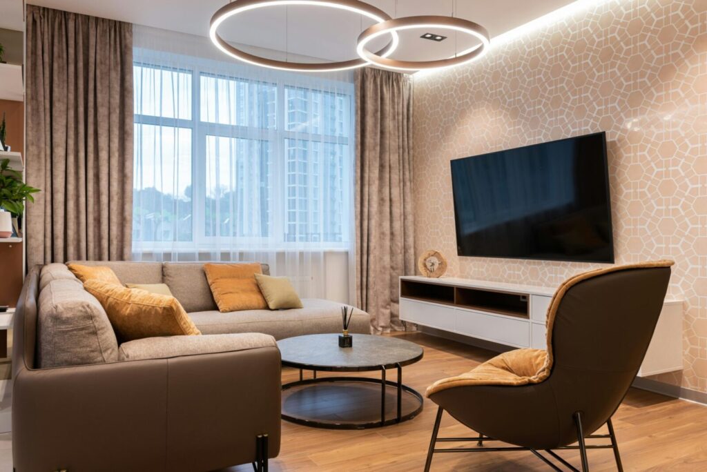 Cozy living room with contemporary furnishings, stylish decor, and a large TV, ideal for relaxation.
