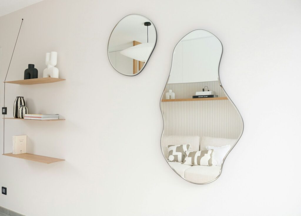 A bathroom with a sink, mirror and shelves