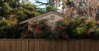 a wooden fence with a house in the background