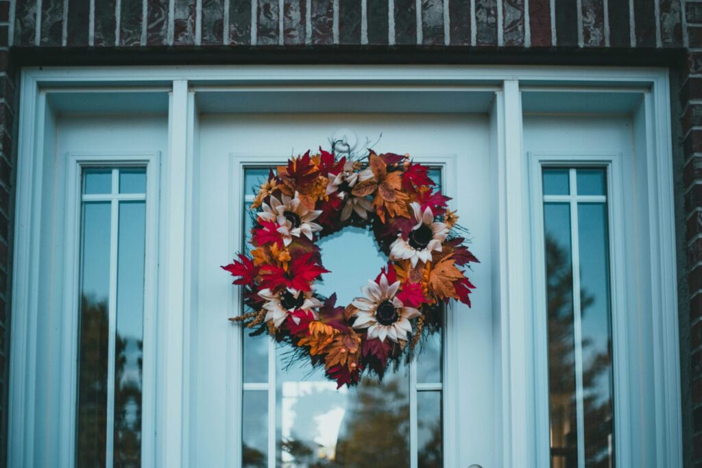 Colorful autumn wreath on a front door, capturing fall's festive charm.
