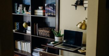 black laptop computer on brown wooden desk