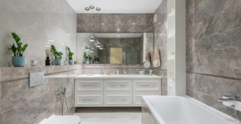 Spacious marble bathroom with sleek fixtures and elegant decor, ideal for luxury home interiors.