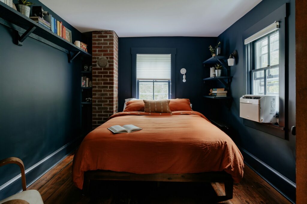 A bed sitting in a bedroom next to a window