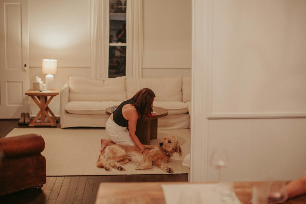 A woman sitting on the floor with her dog