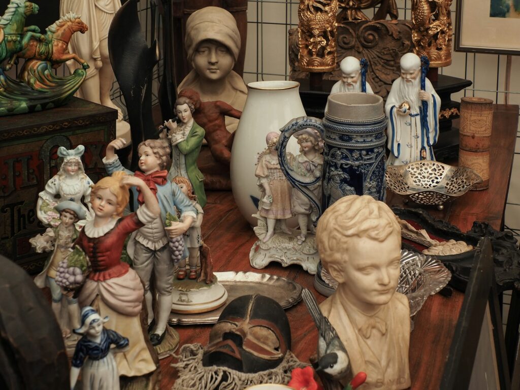 a table topped with lots of figurines on top of a wooden table