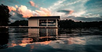 white wooden house on water under blue sky and white clouds during daytime