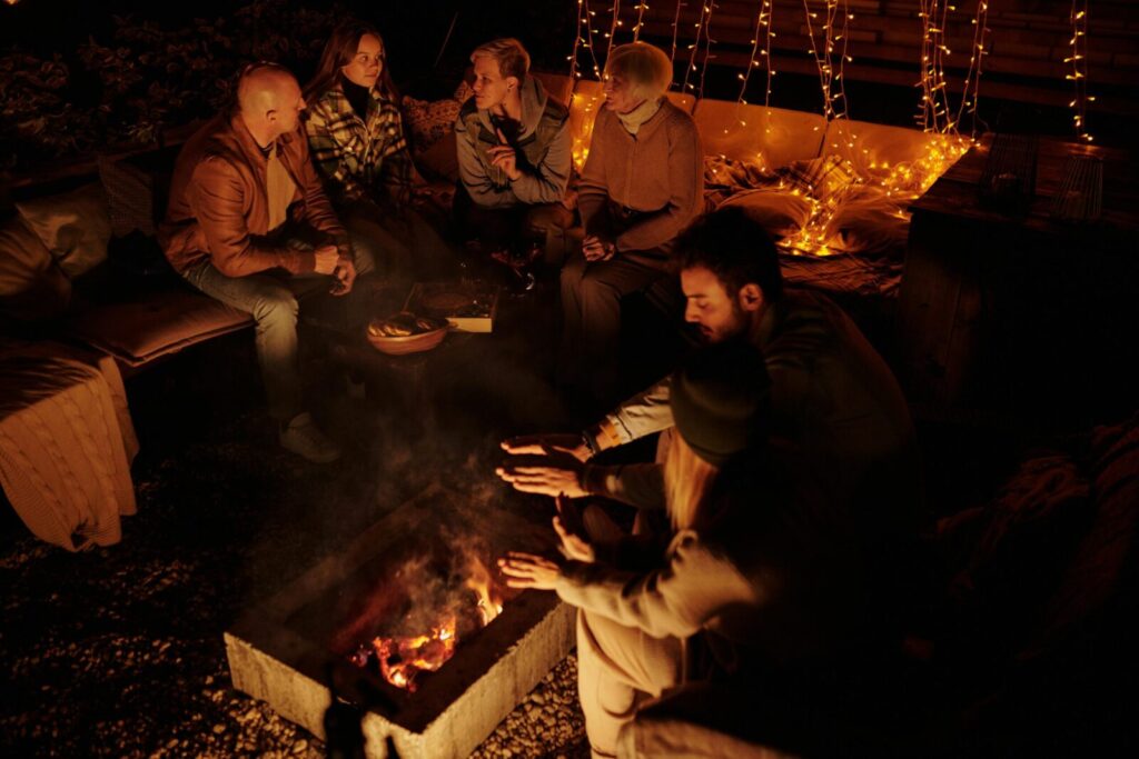 A warm gathering around a bonfire with friends enjoying a cozy night outdoors.