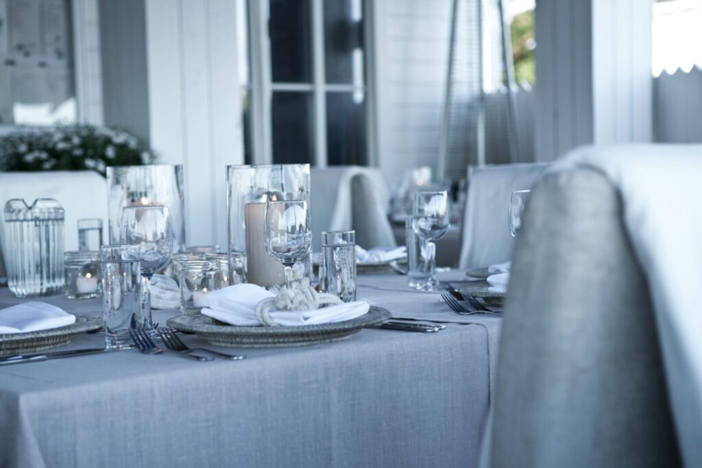 A beautifully set dining table with elegant candlelight ambiance for a luxurious dinner experience.