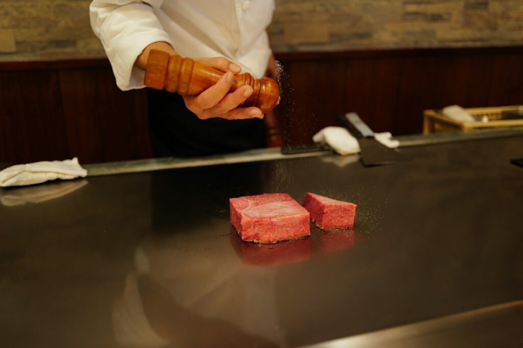 A man in a chef's uniform preparing food on a counter