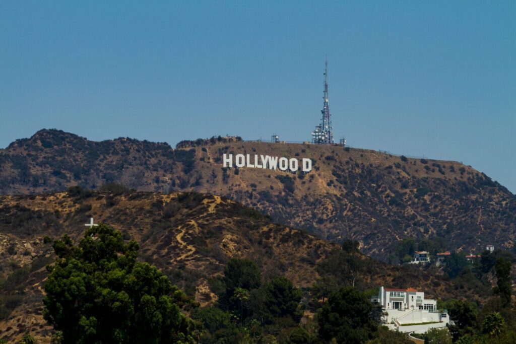 View of the iconic Hollywood Sign on Mount Lee with clear blue skies in Los Angeles, California.