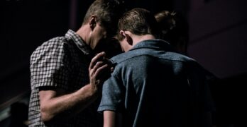 men touching each other's foreheads