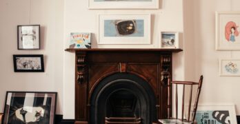 Elegant home interior showcasing artworks and vintage fireplace setting.