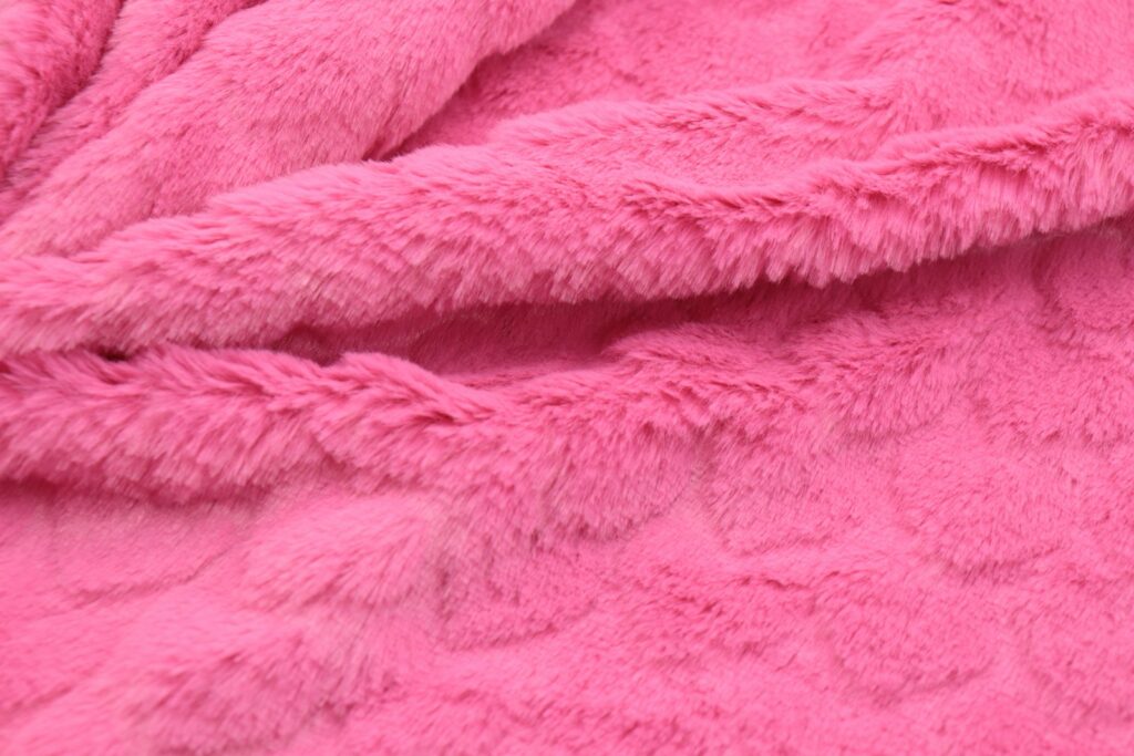 a close up of a pink teddy bear blanket