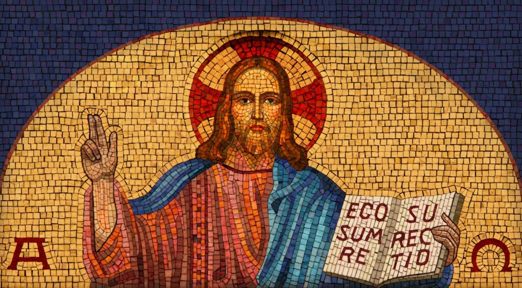 a mosaic of jesus holding a book