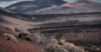 a desert landscape with mountains in the background
