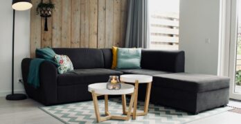 light candle on round white coffee table and sectional sofa