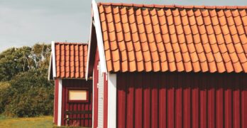 a couple of red buildings with a red roof
