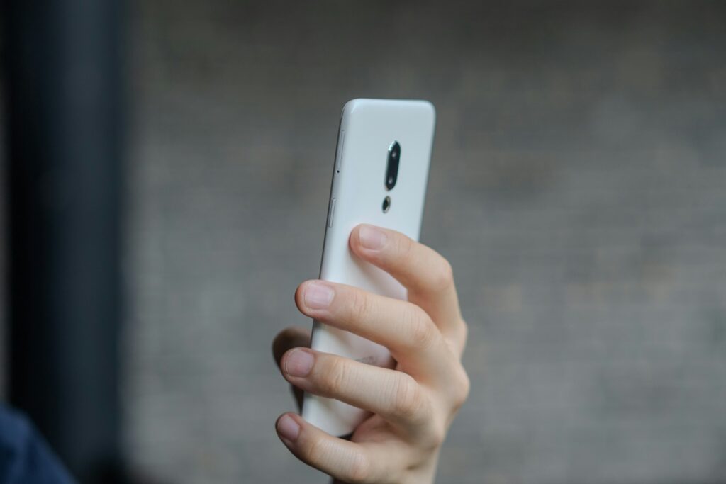 A close up of a person holding a cell phone