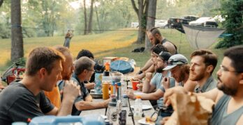 a group of people sitting around a picnic table