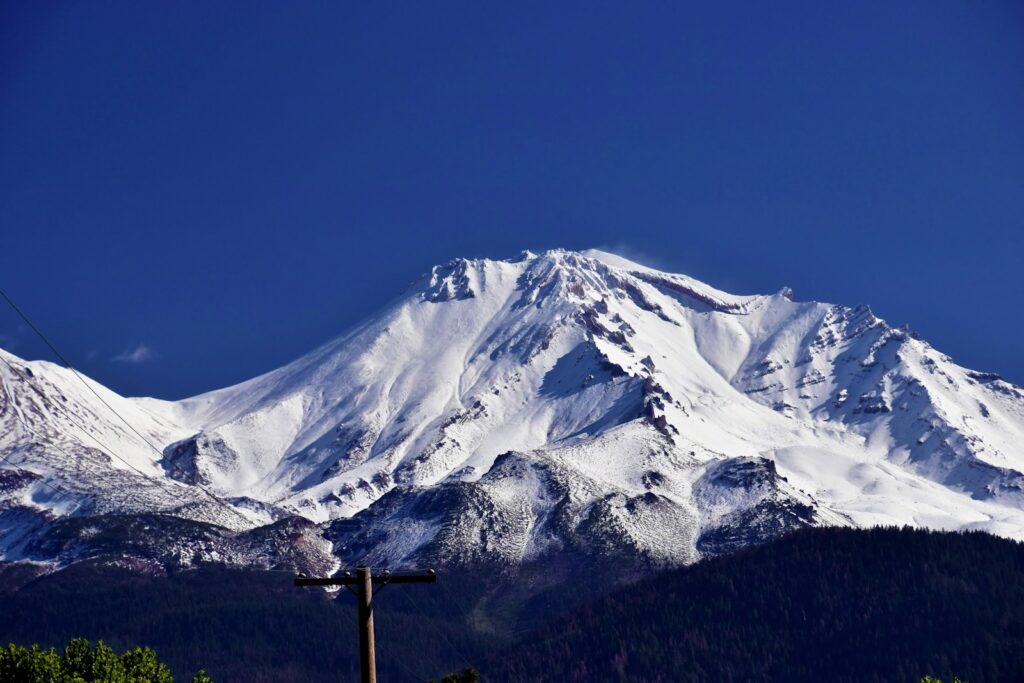 a snowy mountain with a blue sky