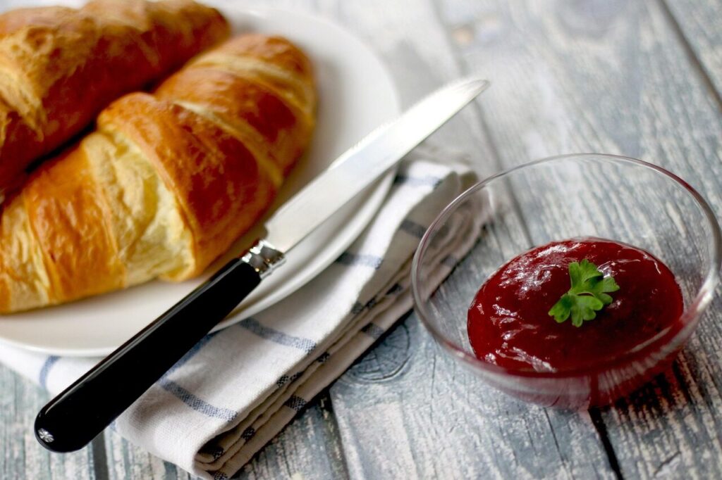 croissants, jam, breakfast, knife, butter knife, breakfast meal, meal, food, breakfast food, bread, plate, jelly, fruit jelly, fruit jam, plate of croissants, danish bread, puff pastry, flaky pastry, baked, bakery, eat, food photography, baked goods, dish, pastries, wooden table, jam, jam, breakfast, breakfast, breakfast, breakfast, breakfast, knife, bread