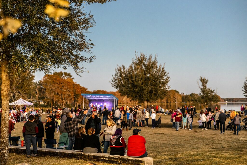 A large crowd enjoys an outdoor festival.