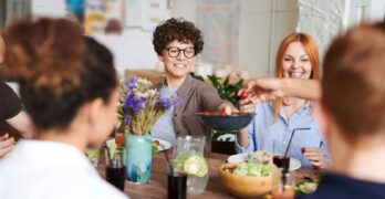 A happy group of friends and family enjoying a meal together indoors. Perfect for themes of togetherness and joy.